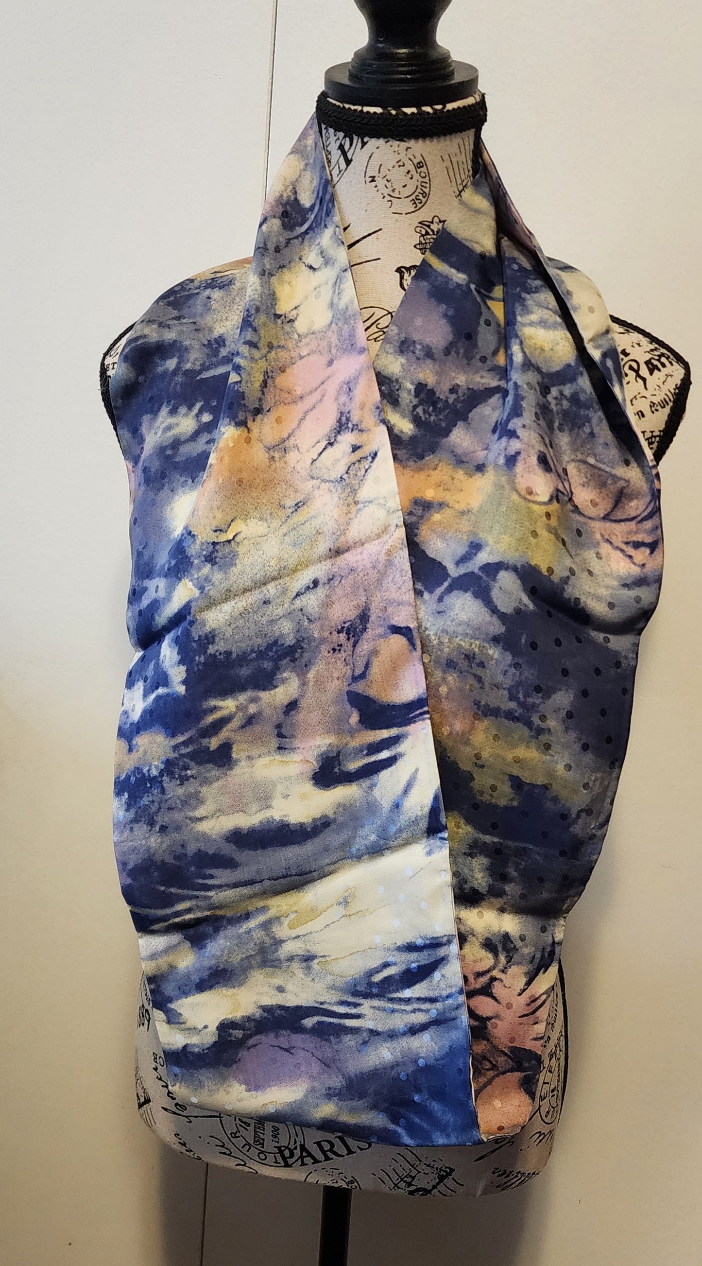 Ungaro silk scarf is soft blues, touch of rose and amber with ecru blend in a pattern like water colours mixing on a canvas