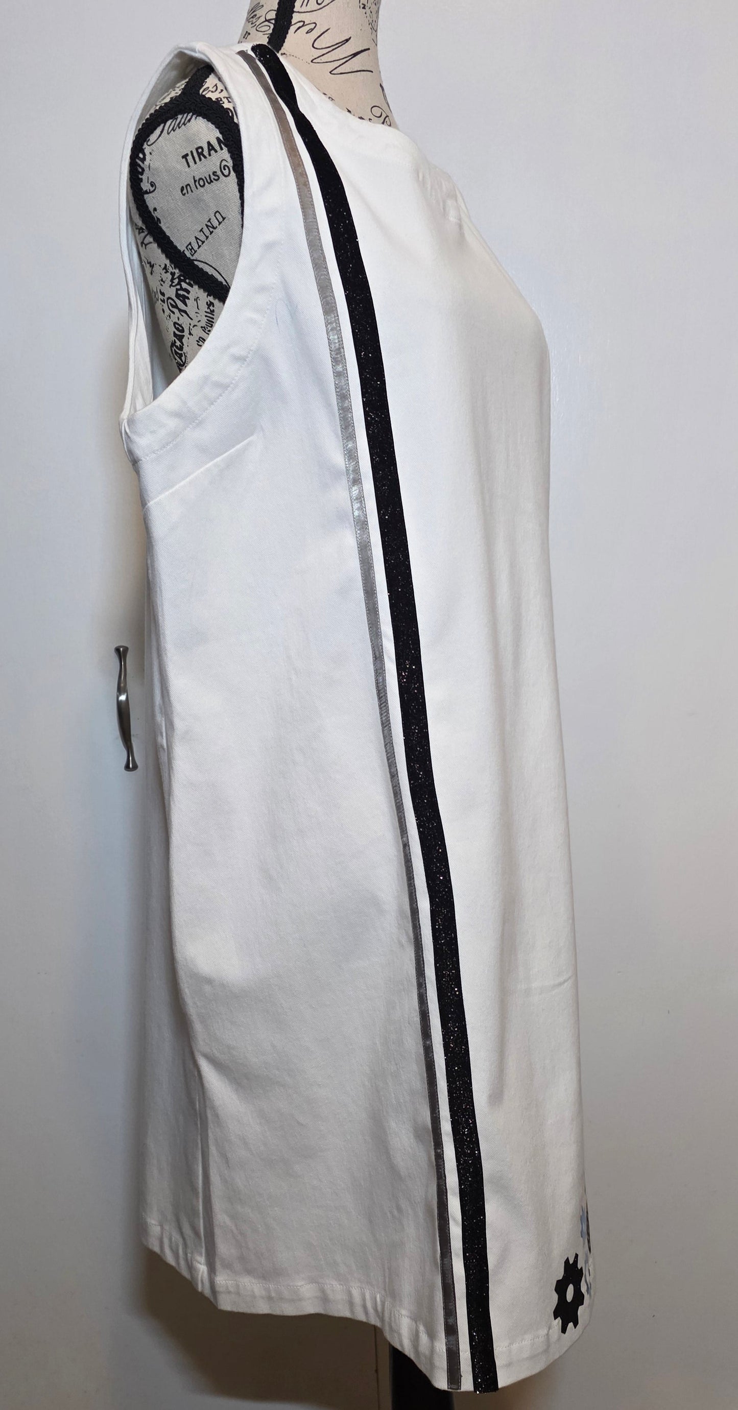 white denim shift dress hand embellished with black, silver and brass steampunk gears arranged asymmetrically along the hem