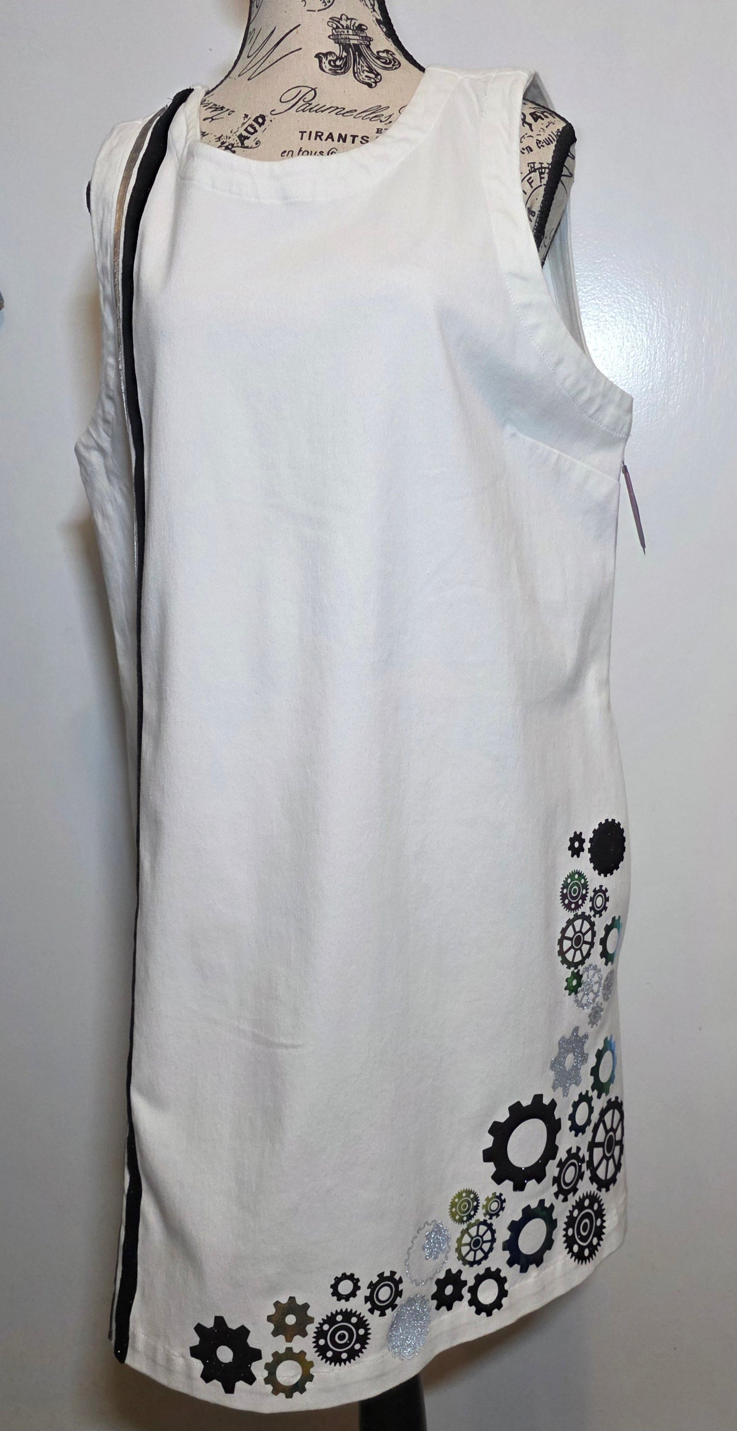 white denim shift dress hand embellished with black, silver and holographic green/gold foil steampunk gears arranged asymmetrically along the hem