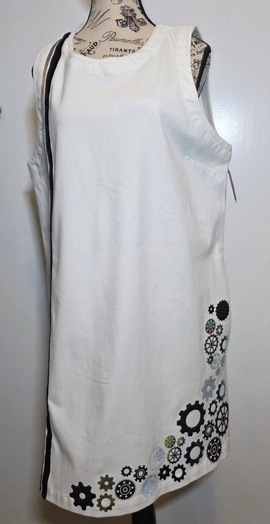 white denim shift dress hand embellished with black, silver and holographic green/gold foil steampunk gears arranged asymmetrically along the hem